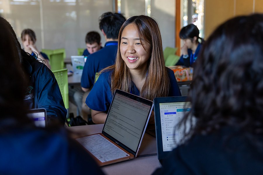 Teen smiling with peers in classroom