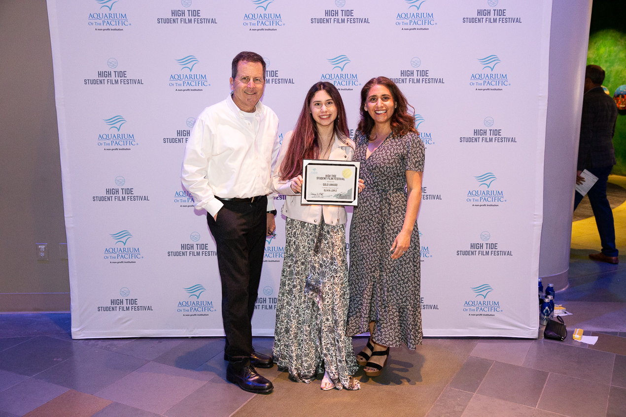 Three people posing in front of sign at High Tide Film Festival