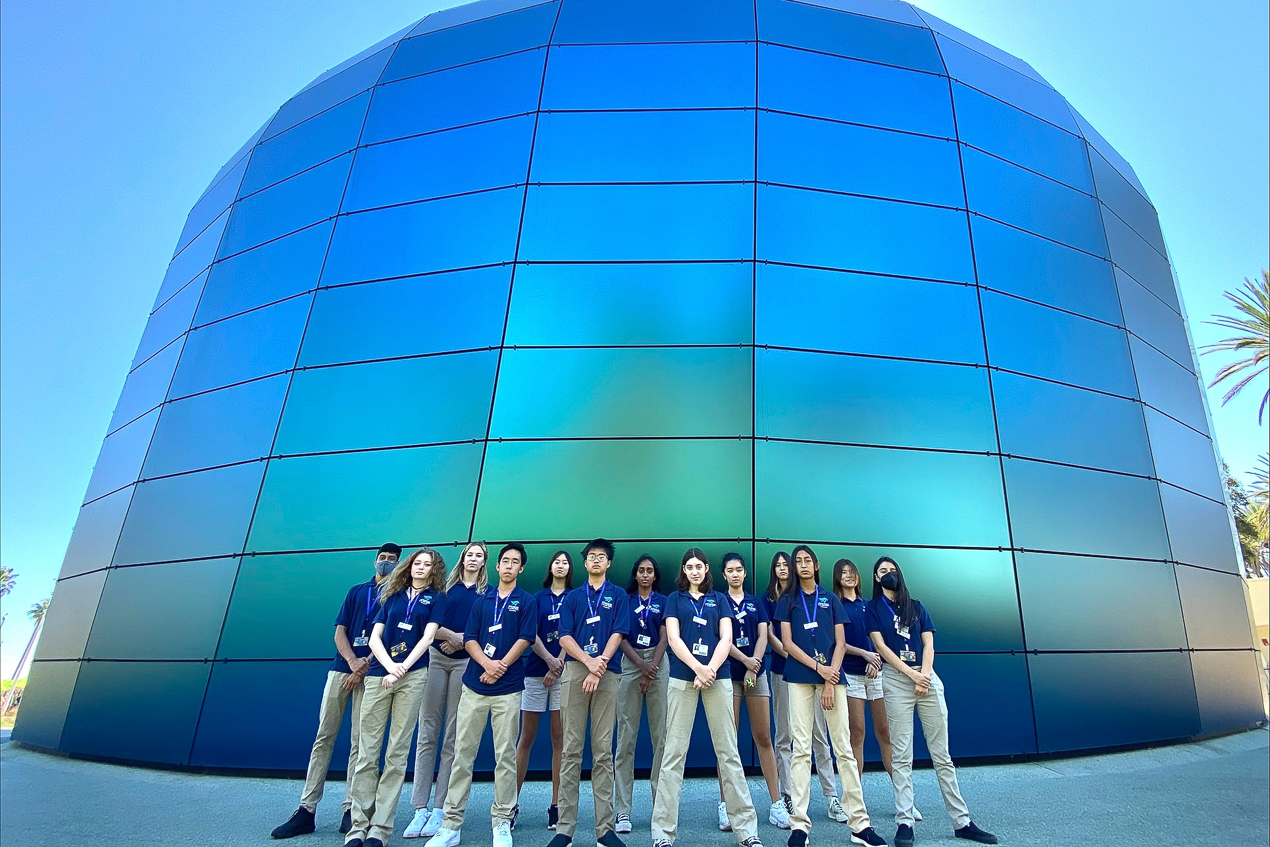 Group of teenagers in Aquarium uniform in front of Pacific Visions